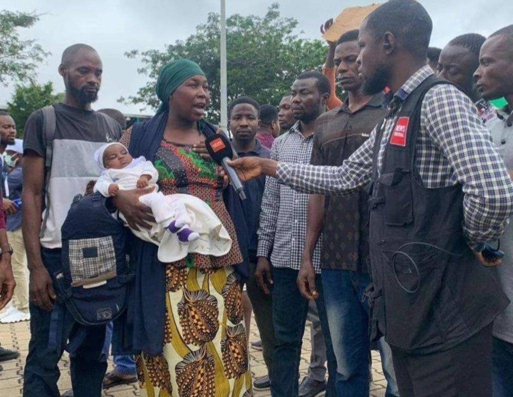 Nursing mother protests with her infant 